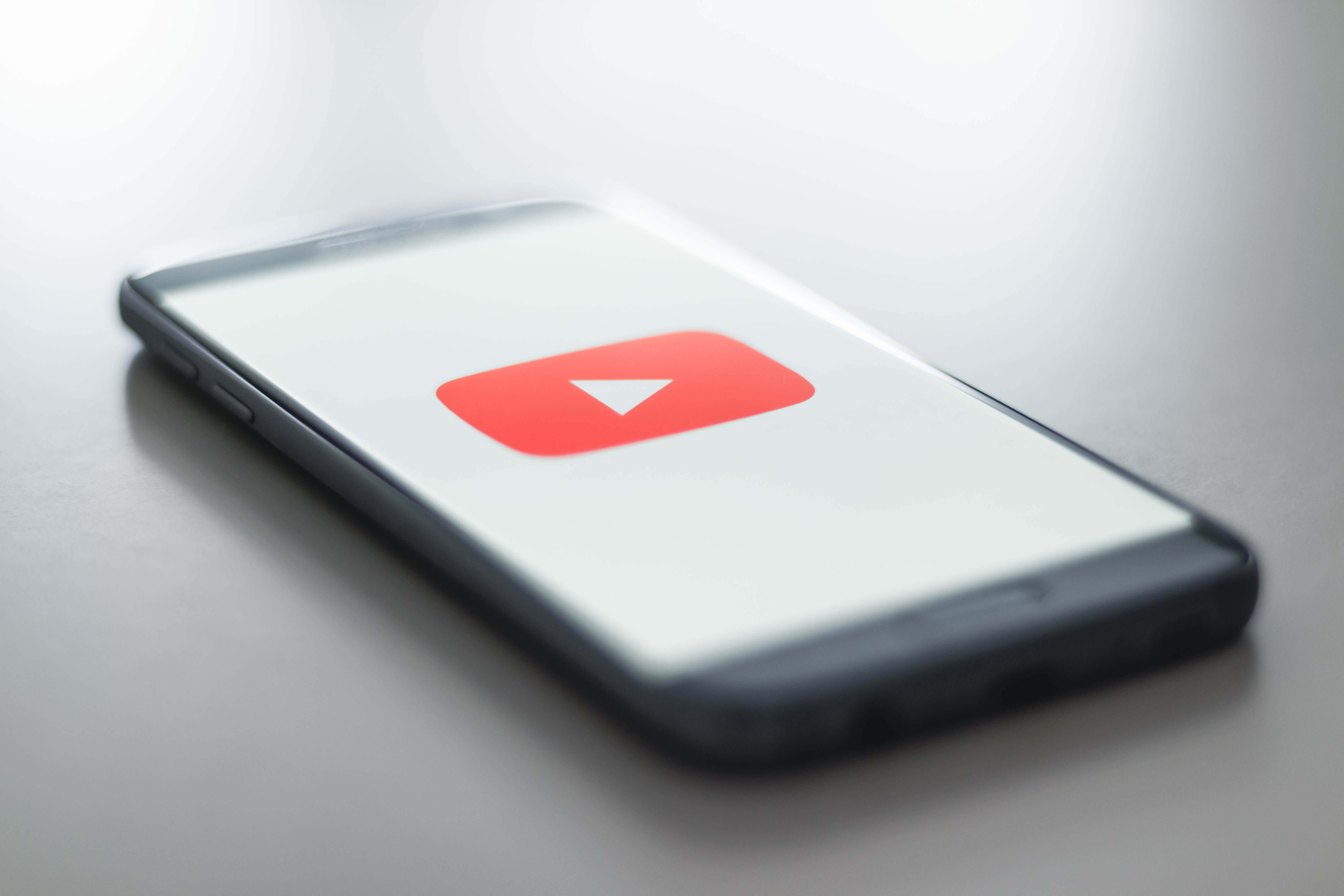 スマートフォンに映るYouTubeのロゴ